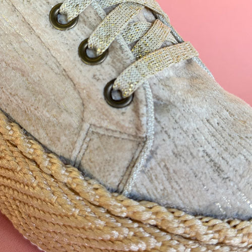 Dalia Cabuya high-top gold tennis shoes