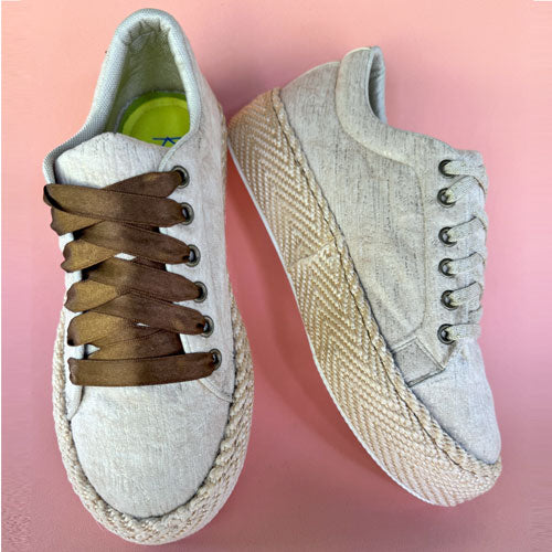 Dalia Cabuya high-top gold tennis shoes
